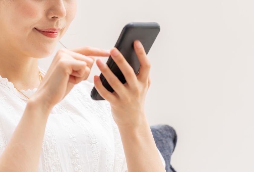 婚活をしている女性がスマホを操作している画像
